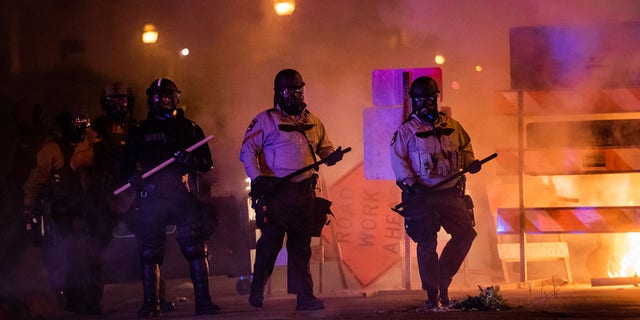 Riot police advance toward protesters in Minneapolis May 30, 2020.