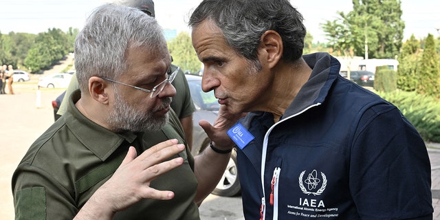 IAEA chief Rafael Grossi, right, talks to Ukainian Minister of Energy German Galushchenko during an inspection mission to Zaporizhzhia, on Aug. 31, 2022.