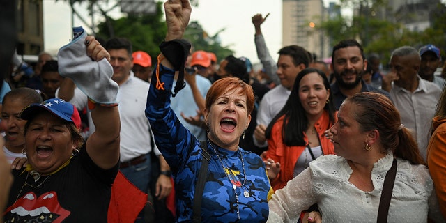 Supporters of Venezuelan opposition leader Juan Guaidó shout slogans during a demonstration to demand a date for presidential elections in Caracas on Oct. 27, 2022.