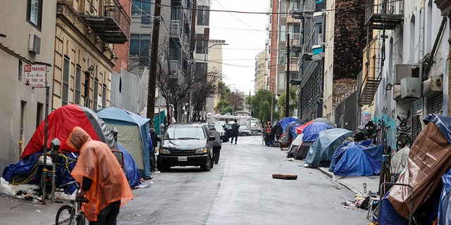 Homeless tents and homeless people are seen by the Polk Street near the City Hall during rainy day in San Francisco on January 13, 2023, as atmospheric river storms hit California, United States. 