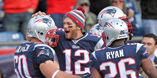 New England Patriots quarterback Tom Brady celebrates defensive end Rob Ninkovich's fumble recovery and touchdown during the first quarter of the NFL game against the Chicago Bears at Gillette Stadium in Foxboro, Massachusetts, on Oct. 26, 2014.