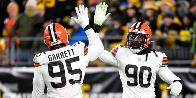 Myles Garrett, #95 of the Cleveland Browns, high-fives teammate Jadeveon Clowney, #90, in the third quarter against the Pittsburgh Steelers at Heinz Field on January 3, 2022, in Pittsburgh, Pennsylvania. 