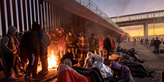 Illegal immigrants gather next to the U.S.-Mexico border fence in El Paso, Texas, on Dec. 22, 2022. 