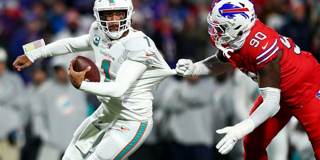 Shaq Lawson (90) of the Buffalo Bills sacks Tua Tagovailoa (1) of the Miami Dolphins during the first quarter of a game at Highmark Stadium Dec. 17, 2022, in Orchard Park, N.Y. 