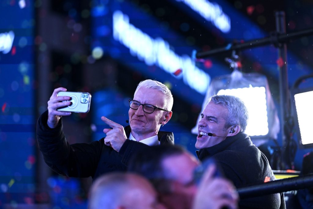 Anderson Cooper and Andy Cohen pose for a selfie during the Times Square New Year's Eve 2023 Celebration on December 31, 2022, in New York City.
