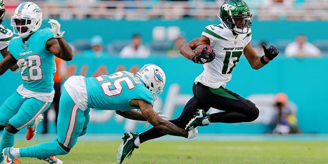 Xavien Howard (25) of the Miami Dolphins tackles Garrett Wilson (17) of the New York Jets during the third quarter at Hard Rock Stadium Jan. 8, 2023, in Miami Gardens, Fla. 