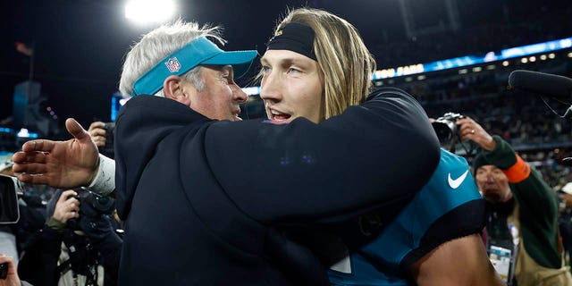 Head coach Doug Pederson and Trevor Lawrence #16 of the Jacksonville Jaguars embrace on the field after defeating the Los Angeles Chargers 31-30 in the AFC Wild Card playoff game at TIAA Bank Field on Jan. 14, 2023 in Jacksonville, Florida. 