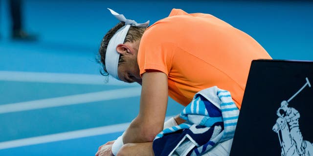 Rafael Nadal of Spain takes a break in the round two singles match against Mackenzie McDonald of the United States during day three of the 2023 Australian Open at Melbourne Park on January 18, 2023, in Melbourne, Australia.