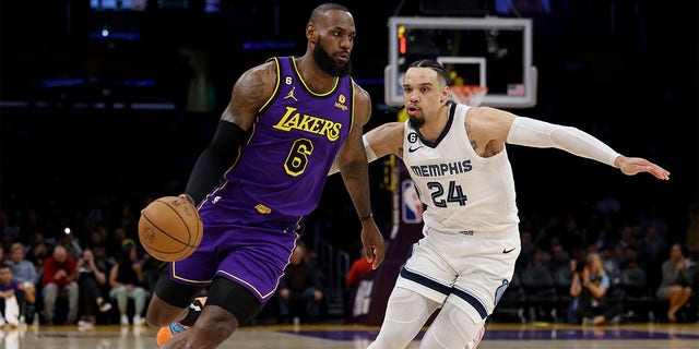 LeBron James, #6 of the Los Angeles Lakers, drives to the basket on Dillon Brooks, #24 of the Memphis Grizzlies, during the first half at Crypto.com Arena on January 20, 2023, in Los Angeles, California. 