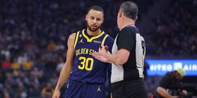 Stephen Curry, #30 of the Golden State Warriors, talks to referee Matt Boland, #18, during the game against the Memphis Grizzlies at Chase Center on January 25, 2023, in San Francisco, California. 