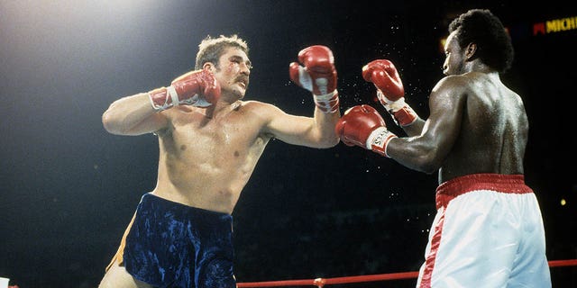 Gerrie Coetzee, left, throws a left punch against Michael Dokes during the fight at the Richfield Coliseum in Richfield, Ohio. Coetzee won the WBA World Heavyweight Title by a KO in the 10th round.