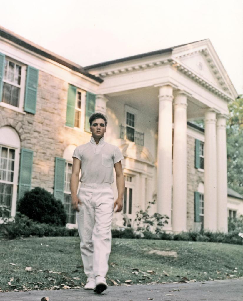Rock and roll singer Elvis Presley strolls the grounds of his Graceland estate in 1957.