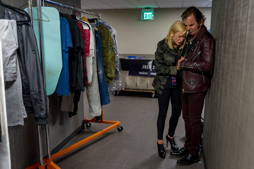 Paula White prays over her husband Jonathan Cain, keyboard player for the band Journey before his band took the stage at the MGM National Harbor casino on July 28, 2017, in National Harbor, MD.
