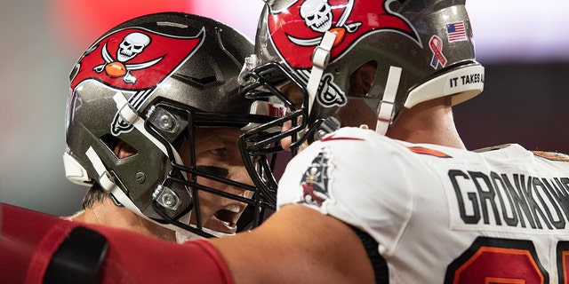 Sep 9, 2021; Tampa, Florida, USA; Tampa Bay Buccaneers quarterback Tom Brady (12) and tight end Rob Gronkowski (87) celebrate after a touchdown against the Dallas Cowboys in the second quarter at Raymond James Stadium.