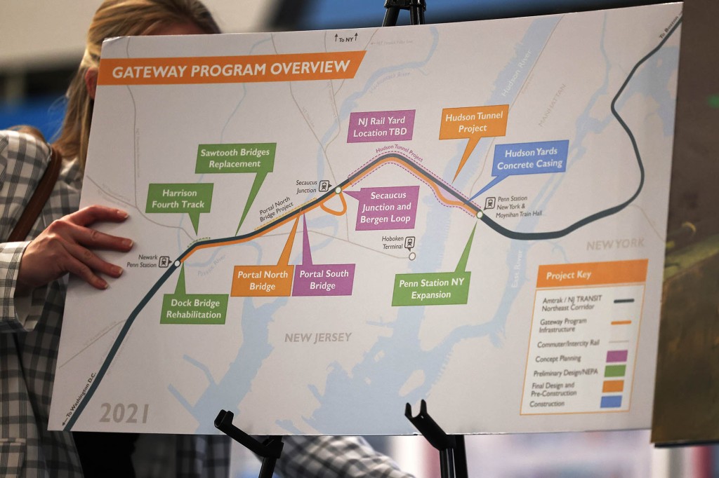 A staffer fixes a Gateway project poster-board before a press conference to announce the "Gateway Turnaround" Hudson Tunnel project at Penn Station on June 28, 2021 in Midtown Manhattan in New York City. 
