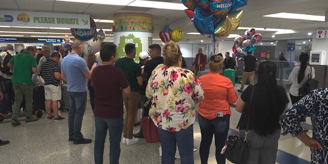 Hundreds of migrants wait to reunite with family at the Miami International Airport. 