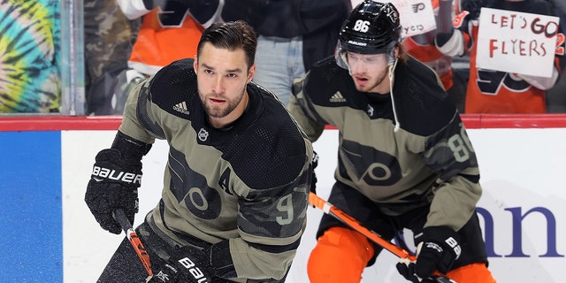 Ivan Provorov, left, and Joel Farabee of the Philadelphia Flyers skate during warm-ups prior to their game against the Toronto Maple Leafs at Wells Fargo Center in Philadelphia on Nov. 10, 2021.