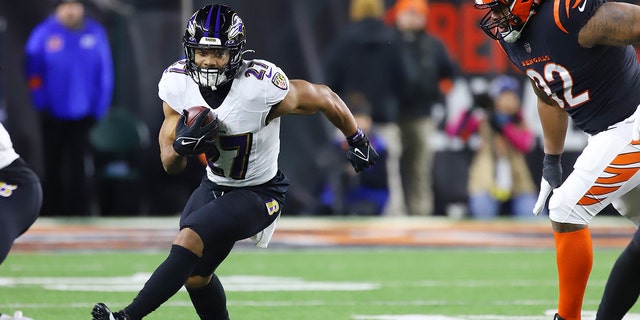 Baltimore Ravens running back J.K. Dobbins runs against the Bengals on Jan. 15, 2023, at Paycor Stadium in Cincinnati.