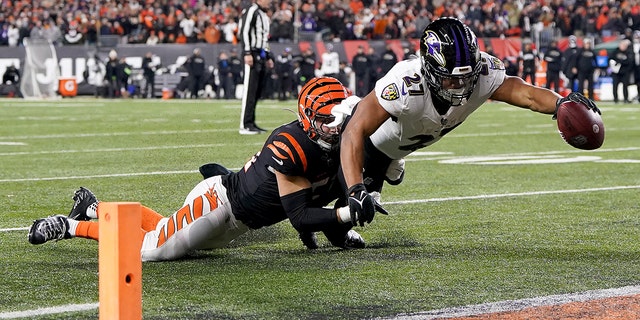 J.K. Dobbins of the Baltimore Ravens dives into the end zone to score against the Bengals during the wild-card playoff game at Paycor Stadium on Jan. 15, 2023, in Cincinnati.