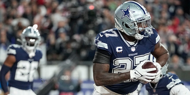 Dallas Cowboys safety Jayron Kearse (27) runs in the end zone after his interception against the Tampa Bay Buccaneers during the first half of an NFL wild-card football game, Monday, Jan. 16, 2023, in Tampa, Fla.