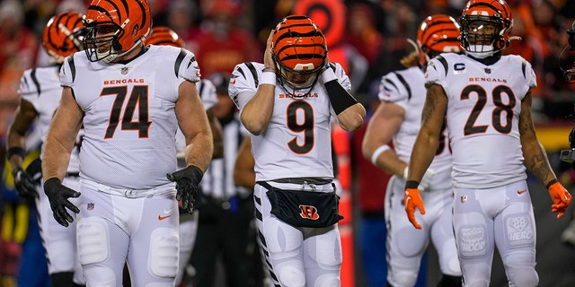 Cincinnati Bengals quarterback Joe Burrow (9) covers his ears to receive a play in the first quarter of the AFC Championship Game against the Kansas City Chiefs, Sunday, Jan. 29, 2023, at Arrowhead Stadium in Kansas City, Missouri.