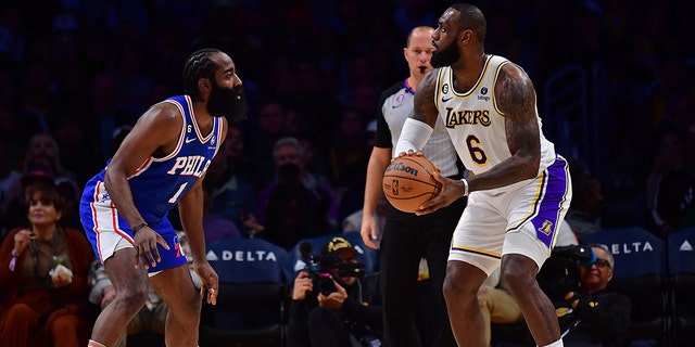 Jan 15, 2023; Los Angeles, California, USA; Los Angeles Lakers forward LeBron James (6) controls the ball against Philadelphia 76ers guard James Harden (1) during the first half at Crypto.com Arena.