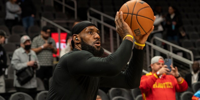 Los Angeles Lakers forward LeBron James warms up before an NBA basketball game against the Atlanta Hawks, Friday, Dec. 30, 2022, in Atlanta. 