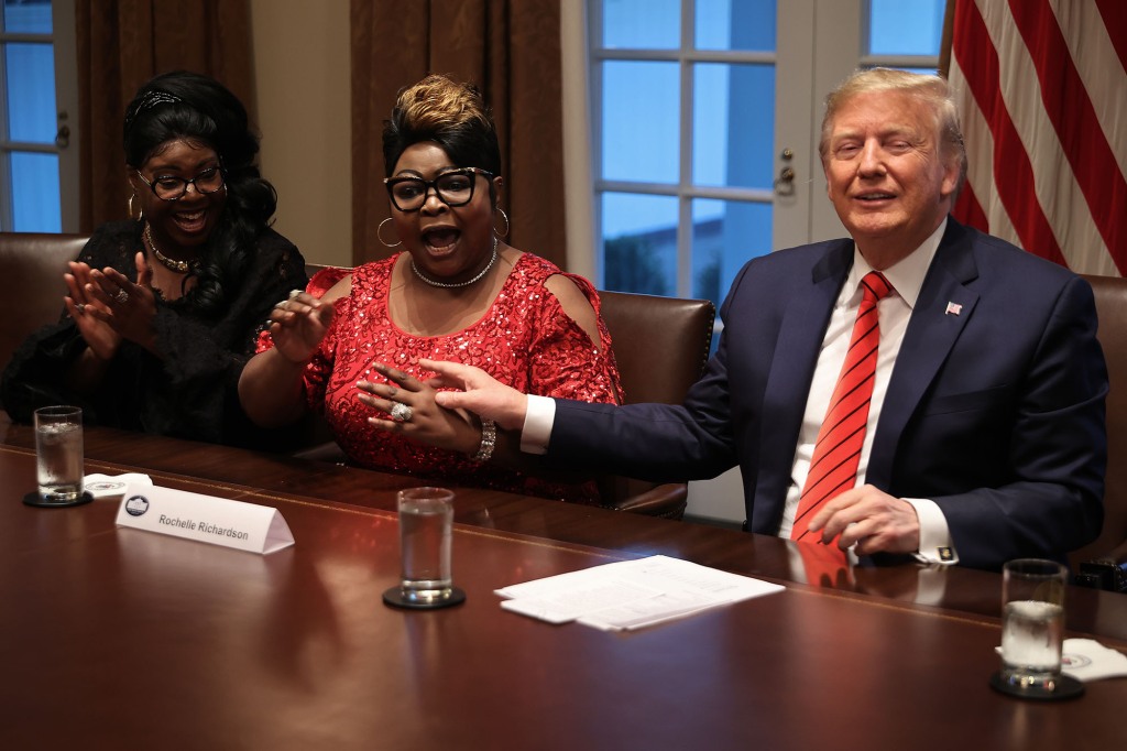 Former President Donald Trump with Lynette 'Diamond' Hardaway (L) and Rochelle 'Silk' Richardson during a meeting with African American supporters in the Cabinet Room at the White House on February 27, 2020.