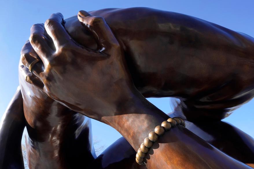 the 20-foot-high bronze sculpture "The Embrace," shows a hand with a bracelet, Tuesday, Jan. 10, 2023, in the Boston Common, in Boston.