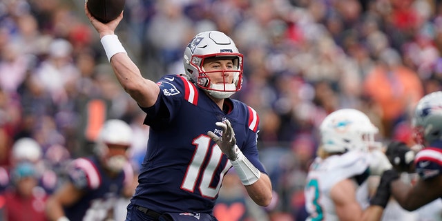 New England Patriots quarterback Mac Jones throws against the Miami Dolphins, Sunday, Jan. 1, 2023, in Foxborough, Massachusetts.