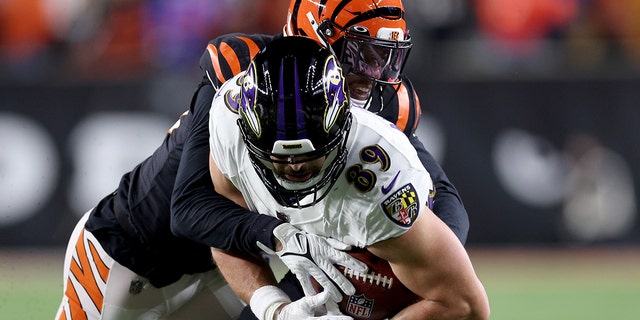 Eli Apple of the Bengals tackles Mark Andrews of the Baltimore Ravens at Paycor Stadium on Jan. 15, 2023 in Cincinnati.