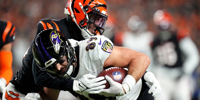 Bengals cornerback Eli Apple tackles Baltimore Ravens tight end Mark Andrews in wild-card playoff game at Paycor Stadium on Jan. 15, 2023, in Cincinnati.