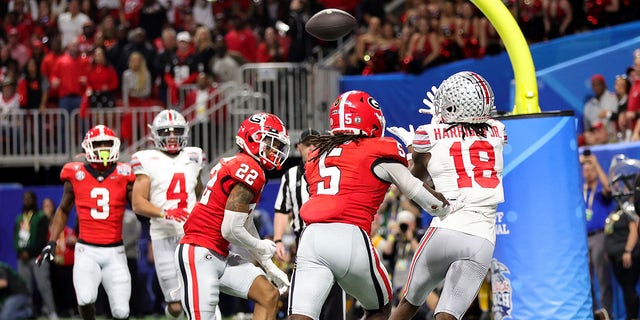 Marvin Harrison Jr. (18) of the Ohio State Buckeyes attempts to catch a pass during the third quarter against the Georgia Bulldogs in the Chick-fil-A Peach Bowl at Mercedes-Benz Stadium Dec. 31, 2022, in Atlanta. 