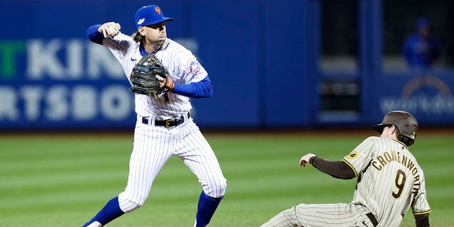 Jeff McNeil of the New York Mets attempts to turn a double play against the San Diego Padres during the fourth inning of game two of the Wild Card Series at Citi Field in New York City on Oct. 8, 2022.