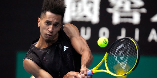 Michael Mmoh plays a backhand return to Alexander Zverev at the Australian Open in Melbourne, Thursday, Jan. 19, 2023.