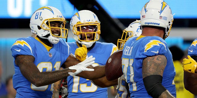 Mike Williams of the Los Angeles Chargers is congratulated by teammates after scoing a touchdown in the first quarter of a game at SoFi Stadium in Inglewood, California, on Dec. 11, 2022.