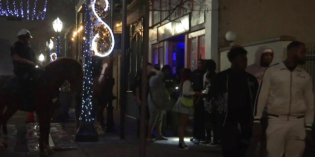 Mounted police patrol New Year's Eve celebrations in downtown Mobile, Ala. after a deadly shooting Saturday night.