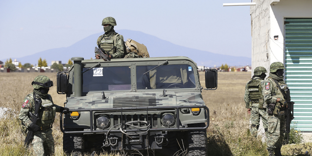 Mexican military personnel at a checkpoint outside the Almoloya prison where Ovidio Guzman, the son of imprisoned drug lord Joaquin "El Chapo" Guzman, is being held in Villa de Almoloya de Juarez, Mexico, on Jan. 6.