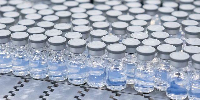 This August 2022 photo provided by Pfizer shows vials of the company's updated COVID-19 vaccine during production in Kalamazoo, Mich. 