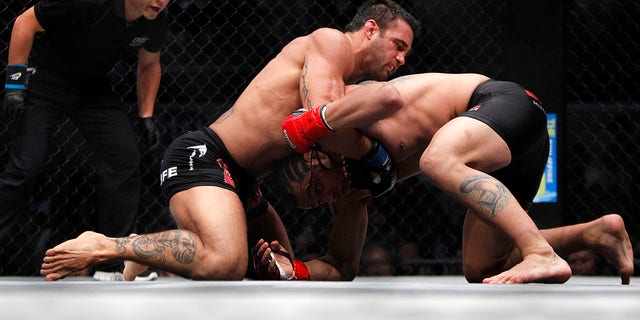 Phil Baroni of the U.S. (C) pins down Brazil's Rodrigo Ribeiro during their ONE Fighting Championship (FC) mixed martial arts (MMA) fight at the Smart Araneta Coliseum in Manila August 31, 2012. Indelibly linked with the 'Thrilla in Manila', where Muhammad Ali and Joe Frazier laid their bitter boxing rivalry to rest some 37 years ago, the Araneta Coliseum welcomed "the future of fighting" on Friday in the Philippines' biggest mixed martial arts (MMA) event. Picture taken August 31, 2012. 