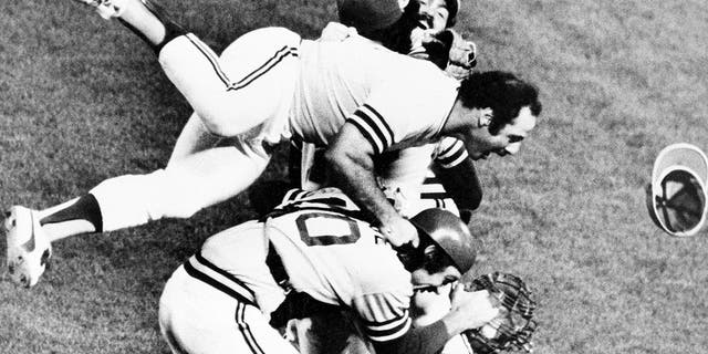 Sal Bando, top, jumps on the heap as the jubilant Athletics whoop it up on the field after beating the Los Angeles Dodgers to win the World Series, on Oct. 17, 1974, in Oakland, California.