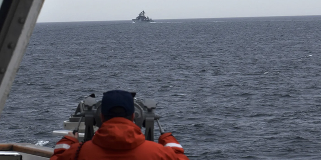 A Coast Guard Cutter Kimball crew-member spots a foreign naval vessel in the Bering Sea on Sept. 19, 2022.  