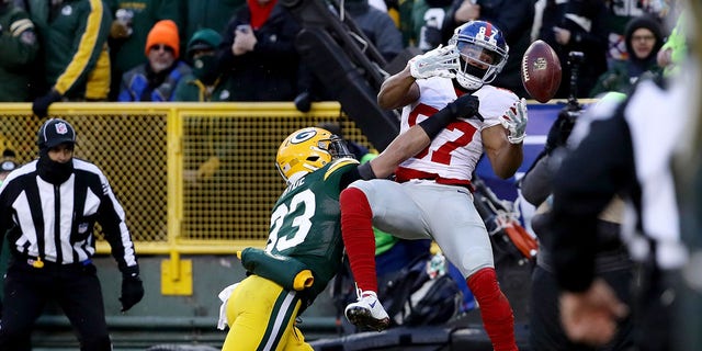 GREEN BAY, WI - JANUARY 8:  Micah Hyde #33 of the Green Bay Packers breaks up a pass intended for Sterling Shepard #87 of the New York Giants in the first quarter during the NFC Wild Card game at Lambeau Field on January 8, 2017, in Green Bay, Wisconsin.