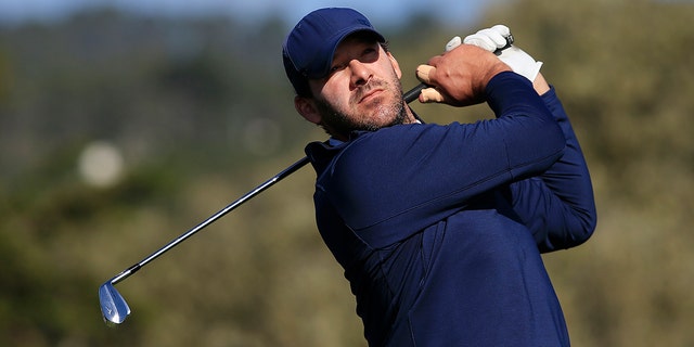 Former NFL player Tony Romo plays his shot from the 17th tee during the third round of the AT&amp;T Pebble Beach Pro-Am at Pebble Beach Golf Links on Feb. 8, 2020 in Pebble Beach, California.