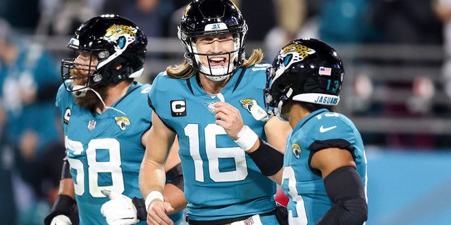 Trevor Lawrence #16 of the Jacksonville Jaguars celebrates with Christian Kirk #13 of the Jacksonville Jaguars after Kirk's receiving touchdown during the second quarter against the Tennessee Titans at TIAA Bank Field on January 07, 2023 in Jacksonville, Florida.