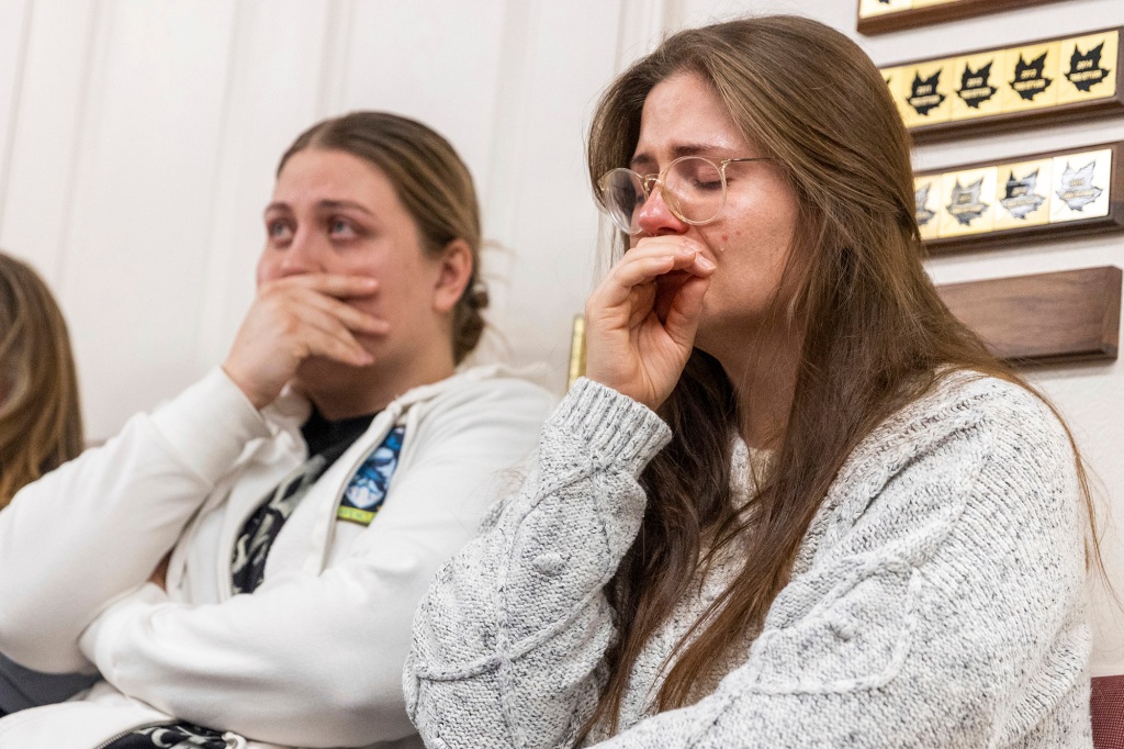 Two women attempt to hold back tears during a press conference about the murder-suicide in Enoch, Utah on Jan. 5, 2023.