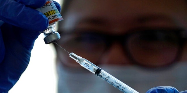 Lurie Children's hospital registered nurse Carolyn Ruyle prepares a dose of a Pfizer COVID-19 vaccine at Lurie Children's hospital Friday, Nov. 5, 2021, in Chicago. 