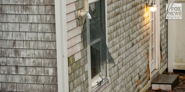 A screen is torn out from the back window of the home at 516 Chief Justice Cushing Hwy in Cohasset, Mass., Friday, Jan. 6, 2023. The home belongs to Ana Walshe, who has been reported missing. She was last seen New Year's Day.