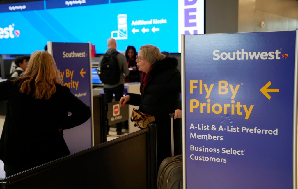 A traveler gets help from at the check-in counter for Southwest Airlines in Denver International Airport Friday, Dec. 30, 2022, in Denver. 