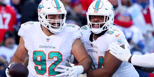 Zach Sieler #92 of the Miami Dolphins celebrates after scoring a touchdown against the Buffalo Bills during the third quarter of the game in the AFC Wild Card playoff game at Highmark Stadium on January 15, 2023 in Orchard Park, New York.